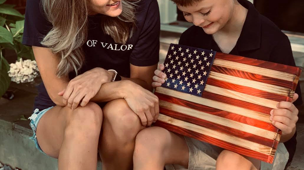 Flags of Valor child holding wooden American flag
