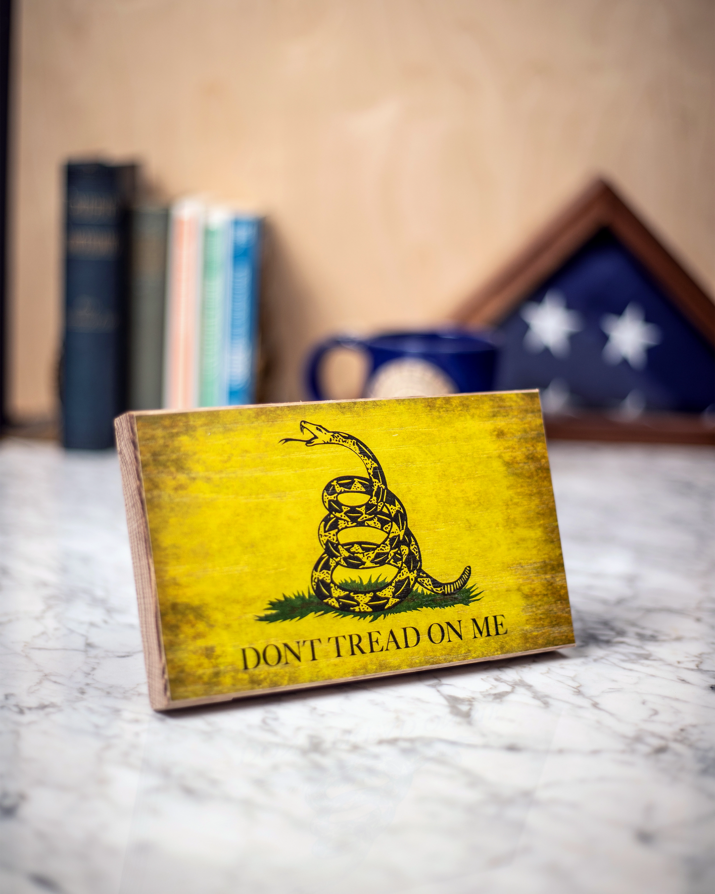 Service Branch Desk Flag featuring Gadsden emblem with books and a mug in the background.
