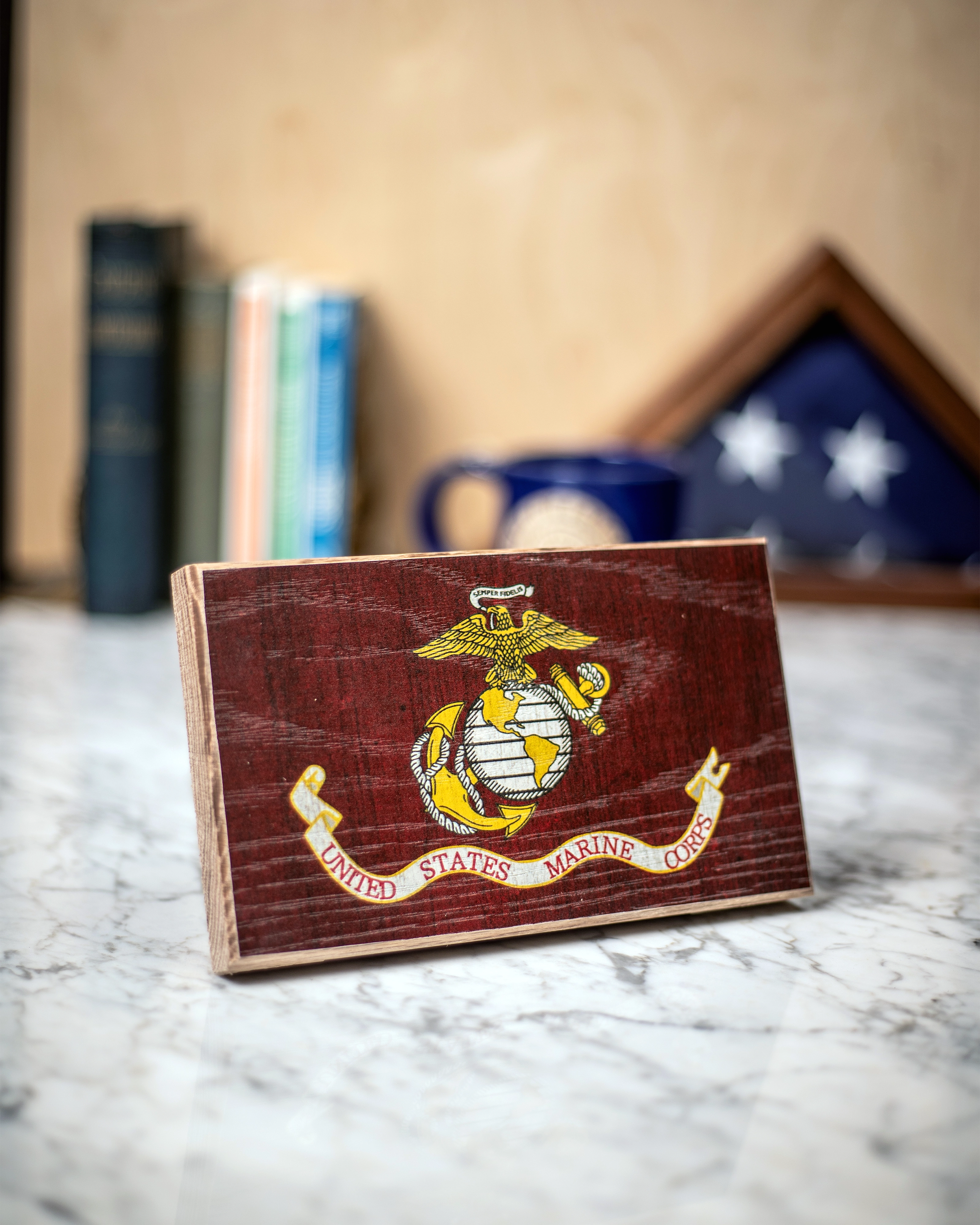 Service Branch Desk Flag featuring United States Marine Corps emblem with books and a mug in the background.