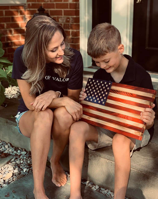 Flags of Valor child holding wooden American flag
