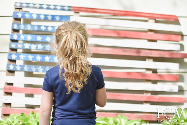 Child says pledge to wooden American Flag, Flags of Valor