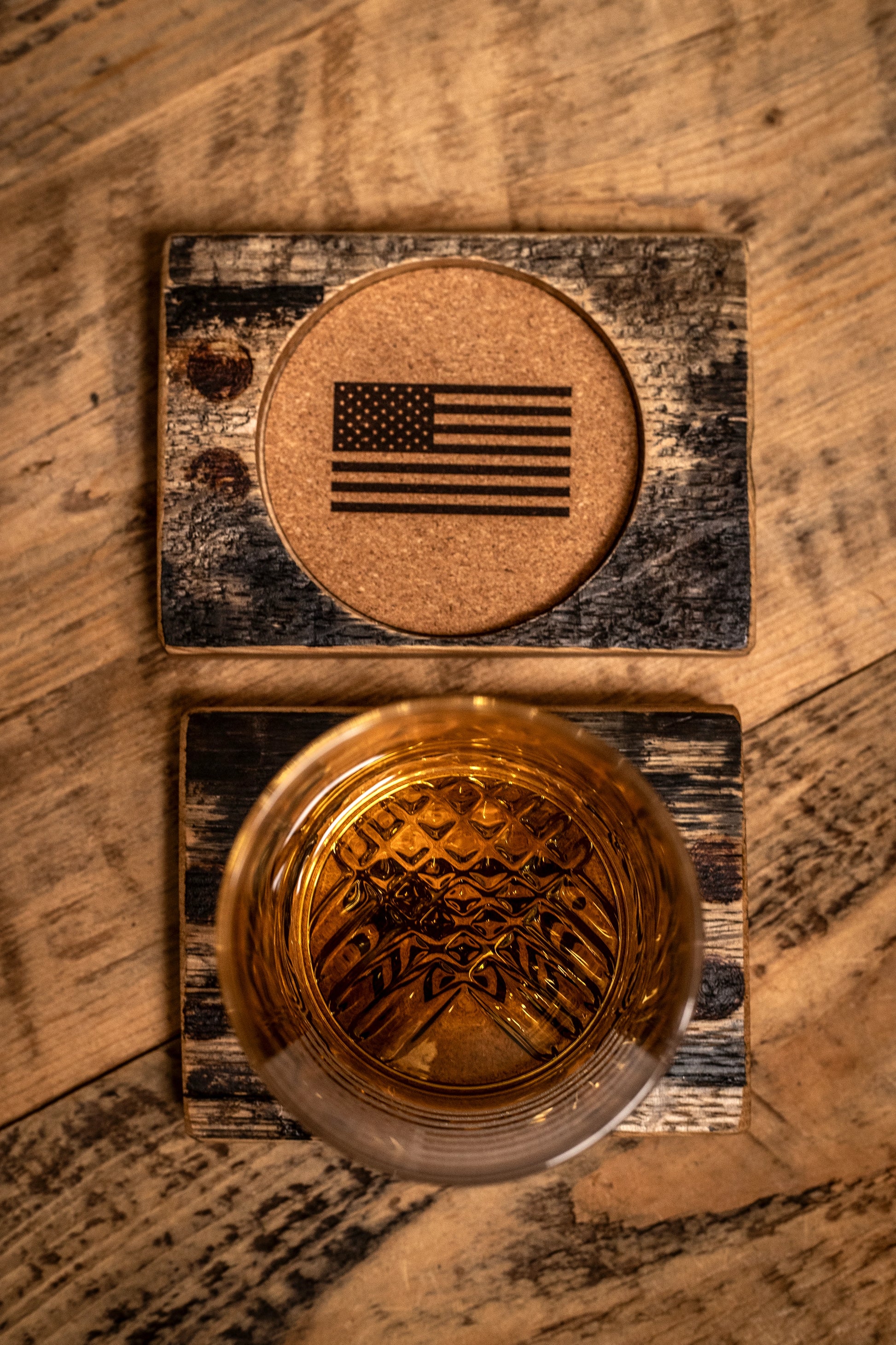 Rocks glass of whiskey with a Flags of Valor bourbon barrel American flag coaster