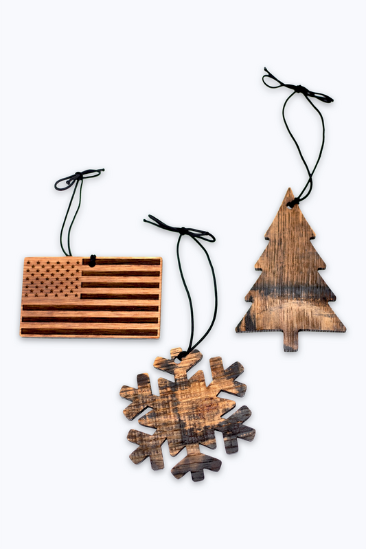 Set of wooden Christmas ornaments including an American flag, tree, and snowflake on a white background.