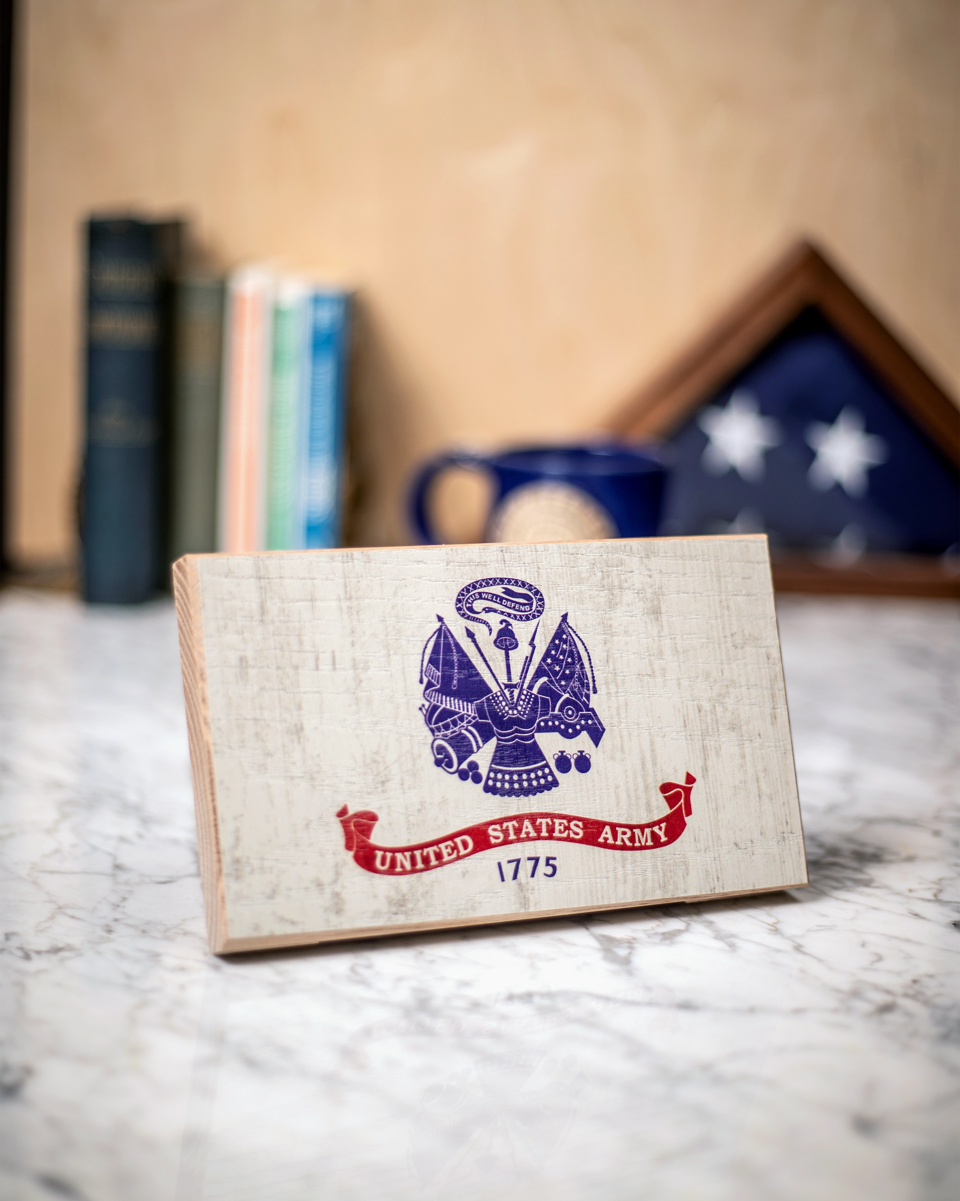 Service Branch Desk Flag featuring United States Army emblem with books and a mug in the background.
