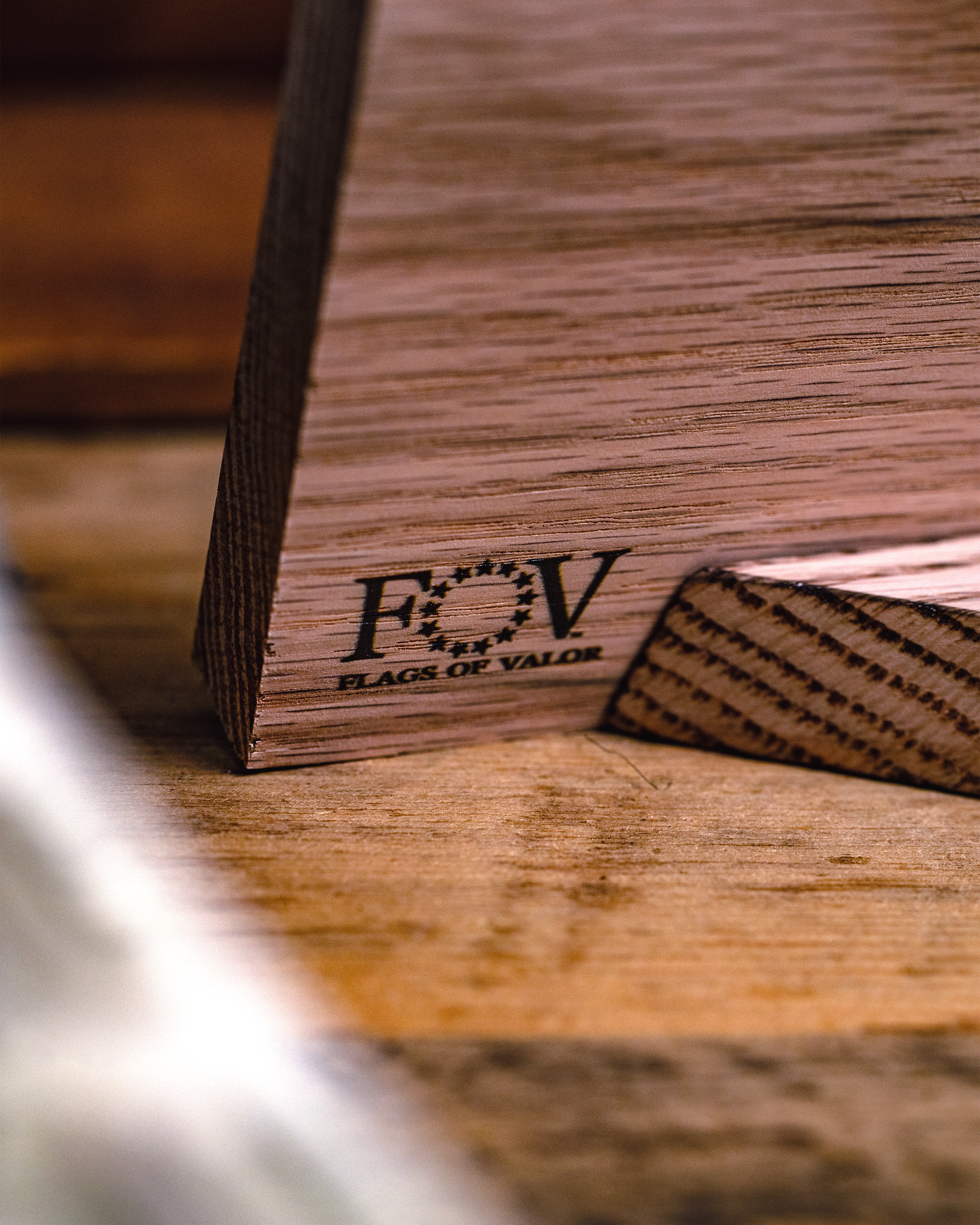 Back of Gadsden wooden desk flag with 'FOV' branding on a wooden surface.